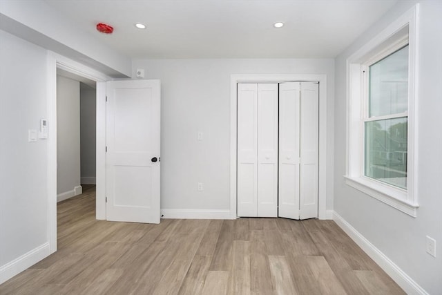 161 Sumner St Unit 1, Quincy, MA 02169 - unfurnished bedroom featuring light wood-type flooring, baseboards, recessed lighting, and a closet
