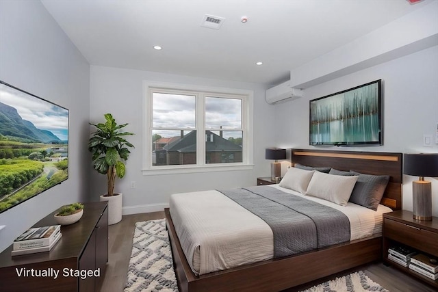 161 Sumner St Unit 1, Quincy, MA 02169 - bedroom with a wall mounted air conditioner, wood finished floors, baseboards, and recessed lighting