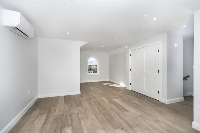 161 Sumner St Unit 1, Quincy, MA 02169 - additional living space featuring an AC wall unit, light wood-style flooring, baseboards, and recessed lighting