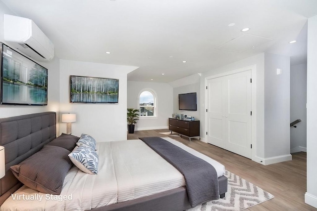 161 Sumner St Unit 1, Quincy, MA 02169 - bedroom featuring a wall unit AC, wood finished floors, baseboards, and recessed lighting