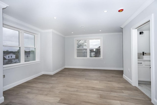 161 Sumner St Unit 1, Quincy, MA 02169 - spare room featuring baseboards, light wood finished floors, ornamental molding, and recessed lighting