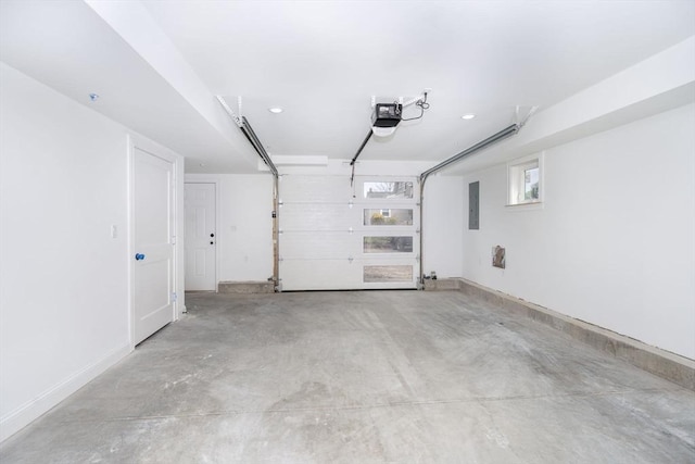 161 Sumner St Unit 1, Quincy, MA 02169 - garage featuring a garage door opener, electric panel, and baseboards