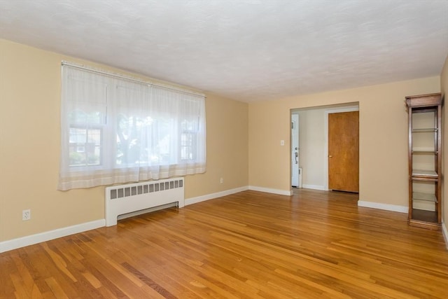 69 Gerald Rd, Milton, MA 02186 - spare room featuring radiator and light wood-style floors