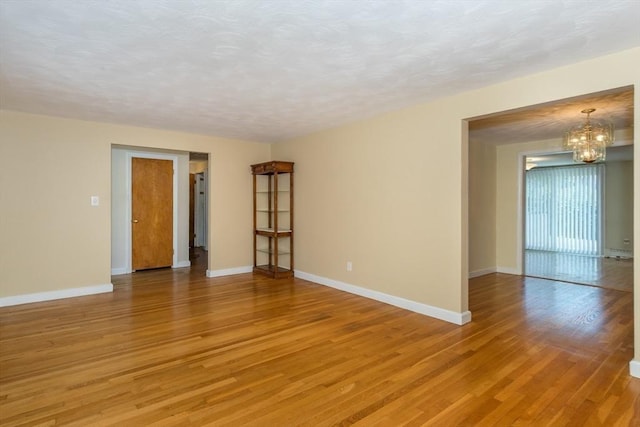 69 Gerald Rd, Milton, MA 02186 - empty room with light wood-style floors and a chandelier