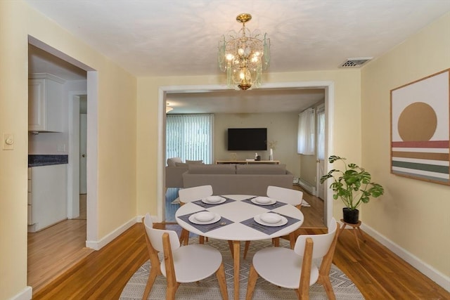69 Gerald Rd, Milton, MA 02186 - dining space with wood finished floors and a chandelier
