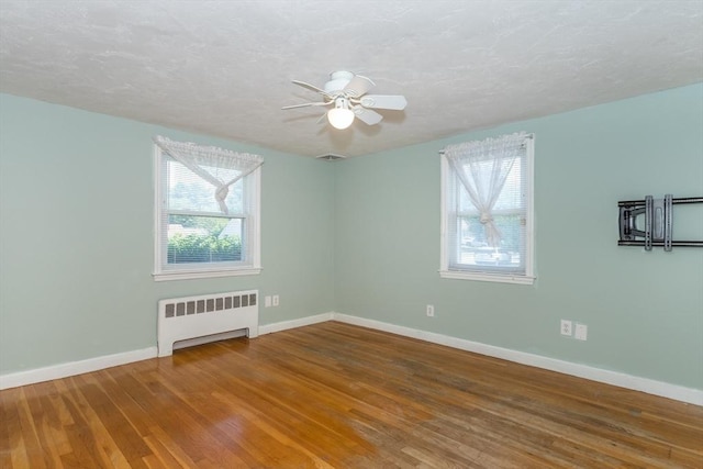 69 Gerald Rd, Milton, MA 02186 - spare room featuring radiator, wood finished floors, a ceiling fan, and a textured ceiling