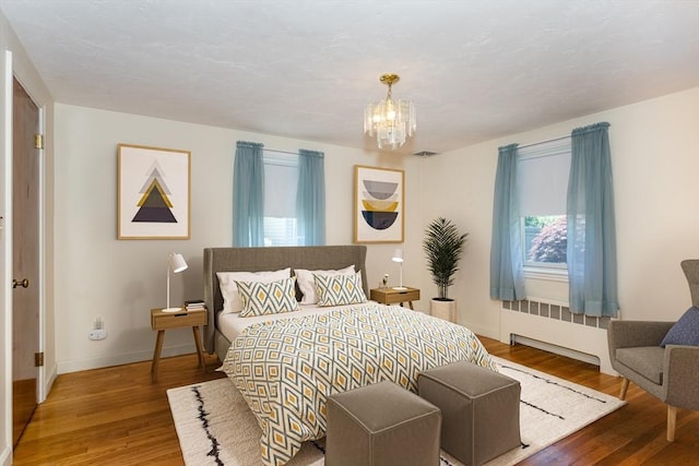 69 Gerald Rd, Milton, MA 02186 - bedroom featuring radiator heating unit, a chandelier, and wood finished floors