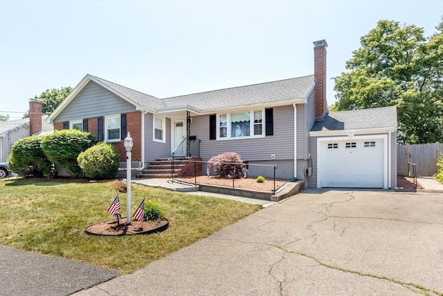 69 Gerald Rd, Milton, MA 02186 - view of front facade with a front lawn, driveway, a chimney, a garage, and brick siding