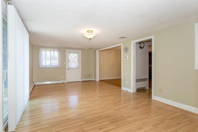 69 Gerald Rd, Milton, MA 02186 - unfurnished room with a baseboard heating unit, light wood-style flooring, and radiator heating unit