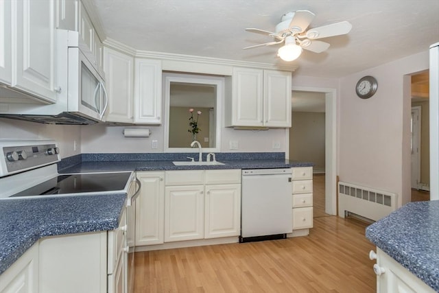 69 Gerald Rd, Milton, MA 02186 - kitchen with white appliances, radiator heating unit, light wood-style floors, ceiling fan, and white cabinets