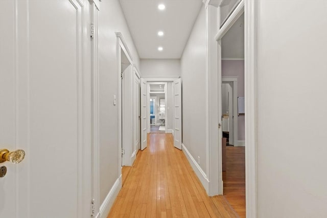 corridor with light hardwood / wood-style floors