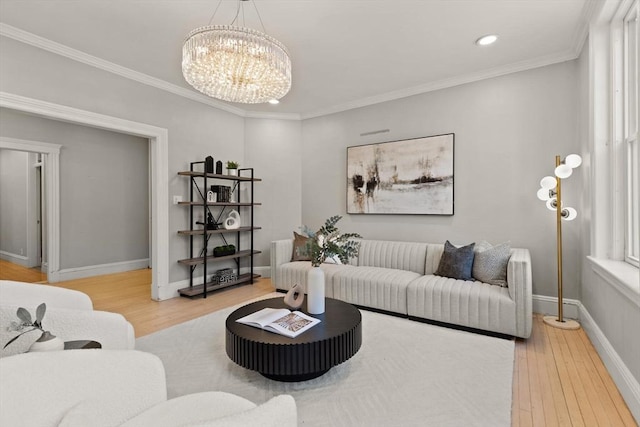 living room with crown molding, a chandelier, and hardwood / wood-style flooring