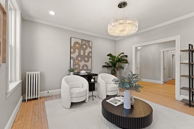 living area with crown molding, radiator heating unit, a chandelier, and wood-type flooring