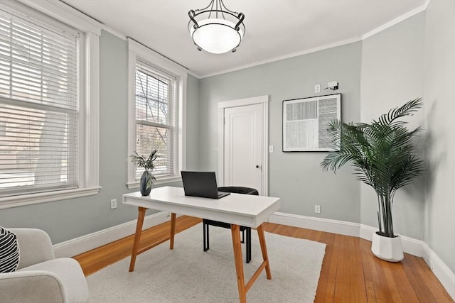 office with light hardwood / wood-style flooring and ornamental molding