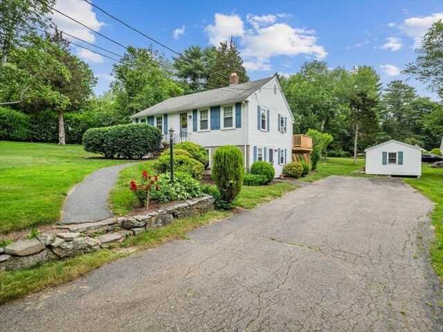 12 Allen St, Pembroke, MA 02359 - view of front of property with driveway, a chimney, a front lawn, and view of scattered trees
