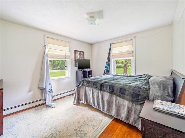 12 Allen St, Pembroke, MA 02359 - bedroom featuring wood finished floors and a baseboard heating unit