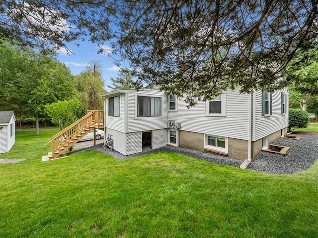 12 Allen St, Pembroke, MA 02359 - rear view of house featuring a lawn and stairway