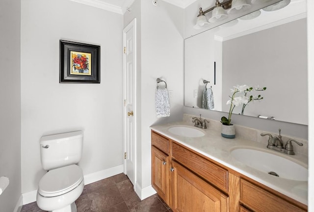 full bathroom with a sink, baseboards, crown molding, and toilet