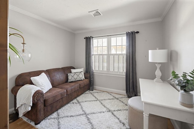 living area featuring baseboards, ornamental molding, and visible vents