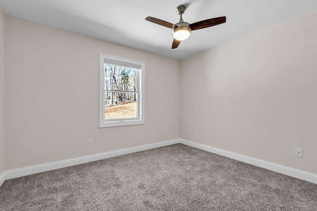 spare room featuring ceiling fan, carpet flooring, and baseboards