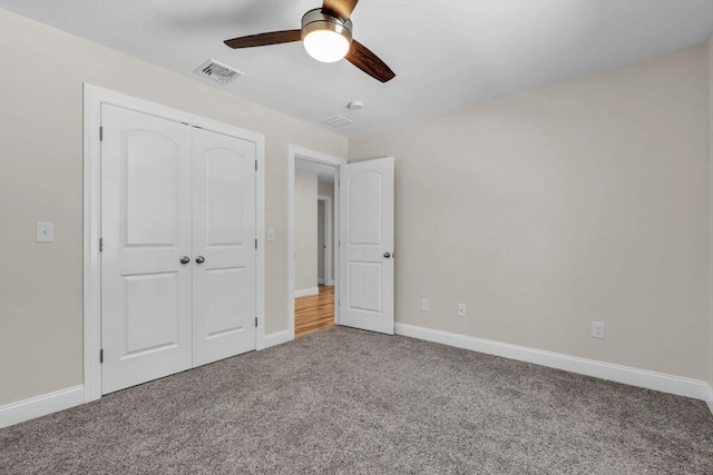 unfurnished bedroom with a closet, visible vents, baseboards, and carpet flooring