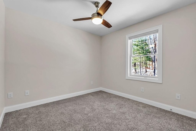 empty room featuring carpet, baseboards, and a ceiling fan