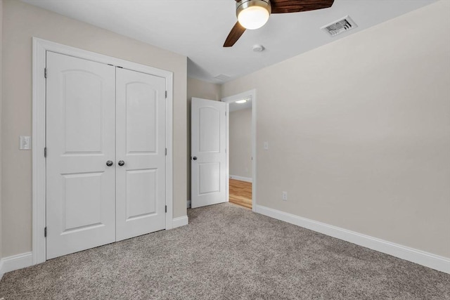 unfurnished bedroom with carpet floors, a closet, visible vents, a ceiling fan, and baseboards