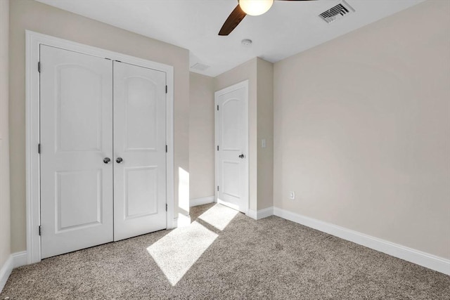 unfurnished bedroom with light colored carpet, a ceiling fan, baseboards, visible vents, and a closet