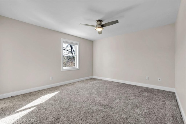 unfurnished room with carpet floors, a ceiling fan, and baseboards