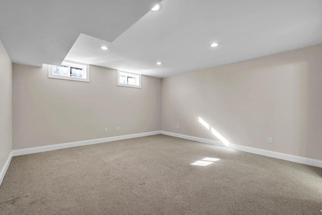 basement featuring carpet floors, baseboards, and recessed lighting