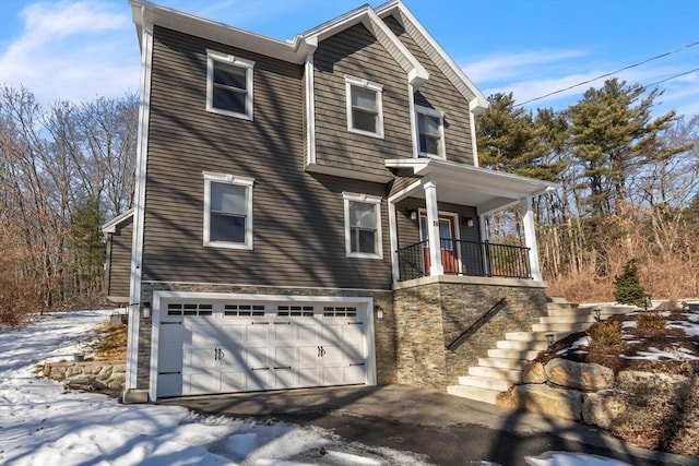 view of front of property with stone siding, stairway, and an attached garage