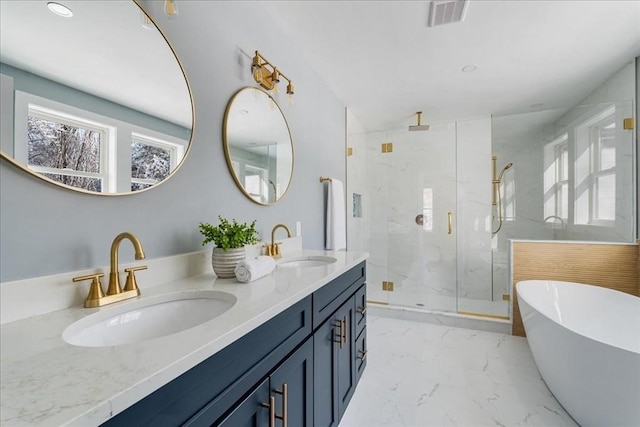 bathroom with vanity and shower with separate bathtub