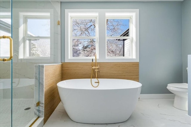 bathroom with plenty of natural light, toilet, and separate shower and tub