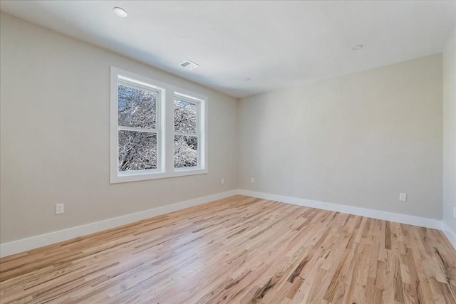 empty room with light hardwood / wood-style flooring