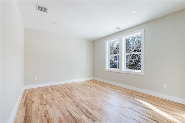 spare room featuring light wood-type flooring