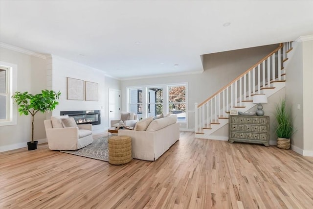 living room featuring light wood-type flooring and ornamental molding