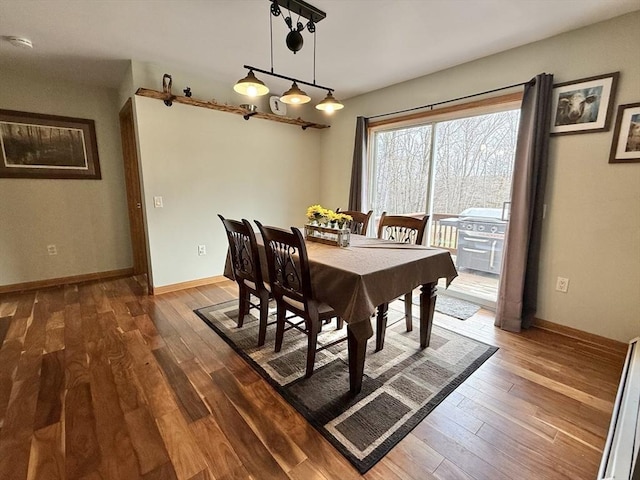 dining room with baseboards and wood finished floors