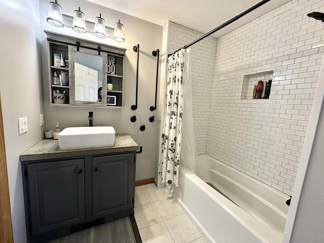 full bath with vanity, tile patterned flooring, baseboards, and shower / bath combo