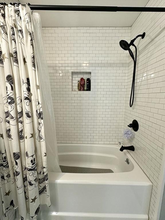 full bathroom with shower / bath combination with curtain