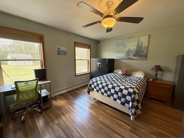 bedroom with wood finished floors, a ceiling fan, and a baseboard heating unit