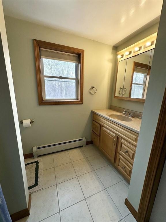 bathroom featuring tile patterned floors, baseboards, baseboard heating, and vanity
