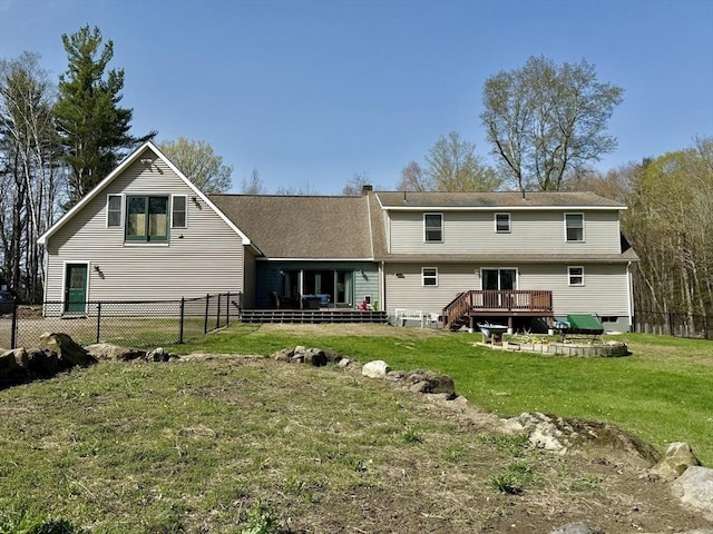 rear view of property with a lawn, a fenced backyard, and a wooden deck