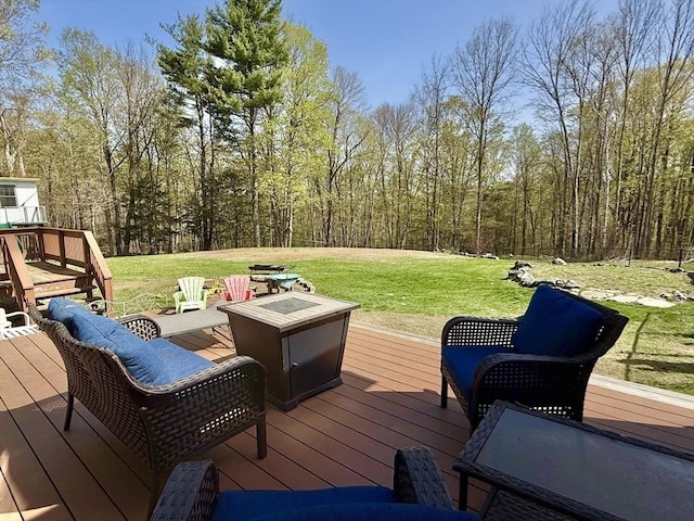 wooden terrace with a lawn and an outdoor fire pit