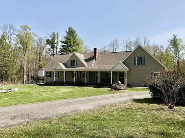 view of front facade with dirt driveway, a chimney, a porch, and a front lawn