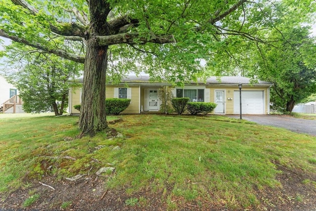 531 Regan Rd, Somerset, MA 02726 - view of front of house with a garage, asphalt driveway, and a front yard