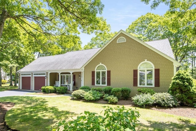 9 Dacey Dr, Barnstable, MA 02632 - single story home with a garage, asphalt driveway, roof with shingles, a porch, and a front yard