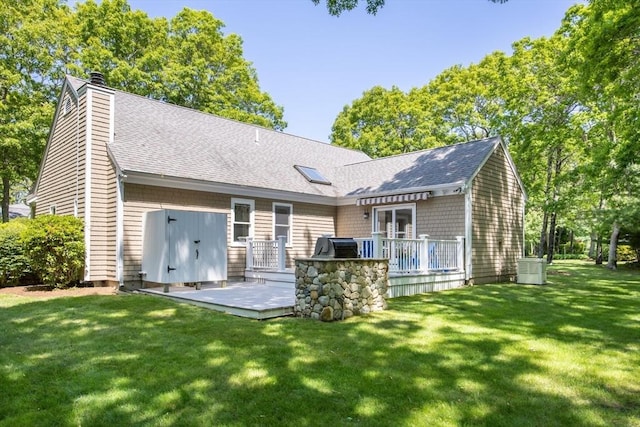 9 Dacey Dr, Barnstable, MA 02632 - rear view of house featuring a deck, roof with shingles, a yard, and a chimney