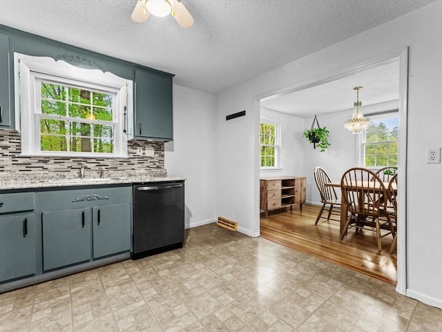 kitchen featuring dishwasher, a sink, tasteful backsplash, baseboards, and a ceiling fan