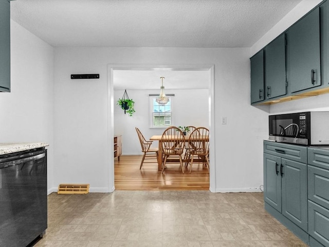 kitchen featuring dishwasher, baseboards, light countertops, and a textured ceiling