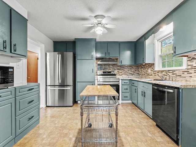 kitchen with appliances with stainless steel finishes, under cabinet range hood, ceiling fan, tasteful backsplash, and a textured ceiling